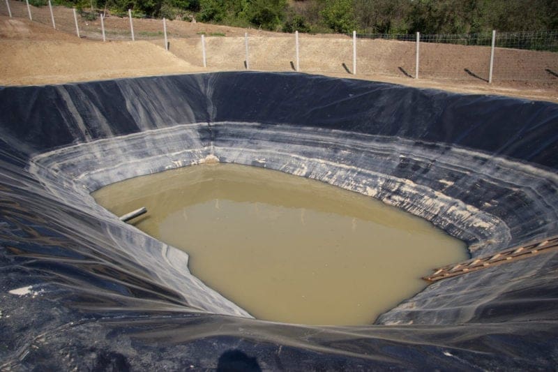 Insulated leachate pond with dirty water, part of landfill