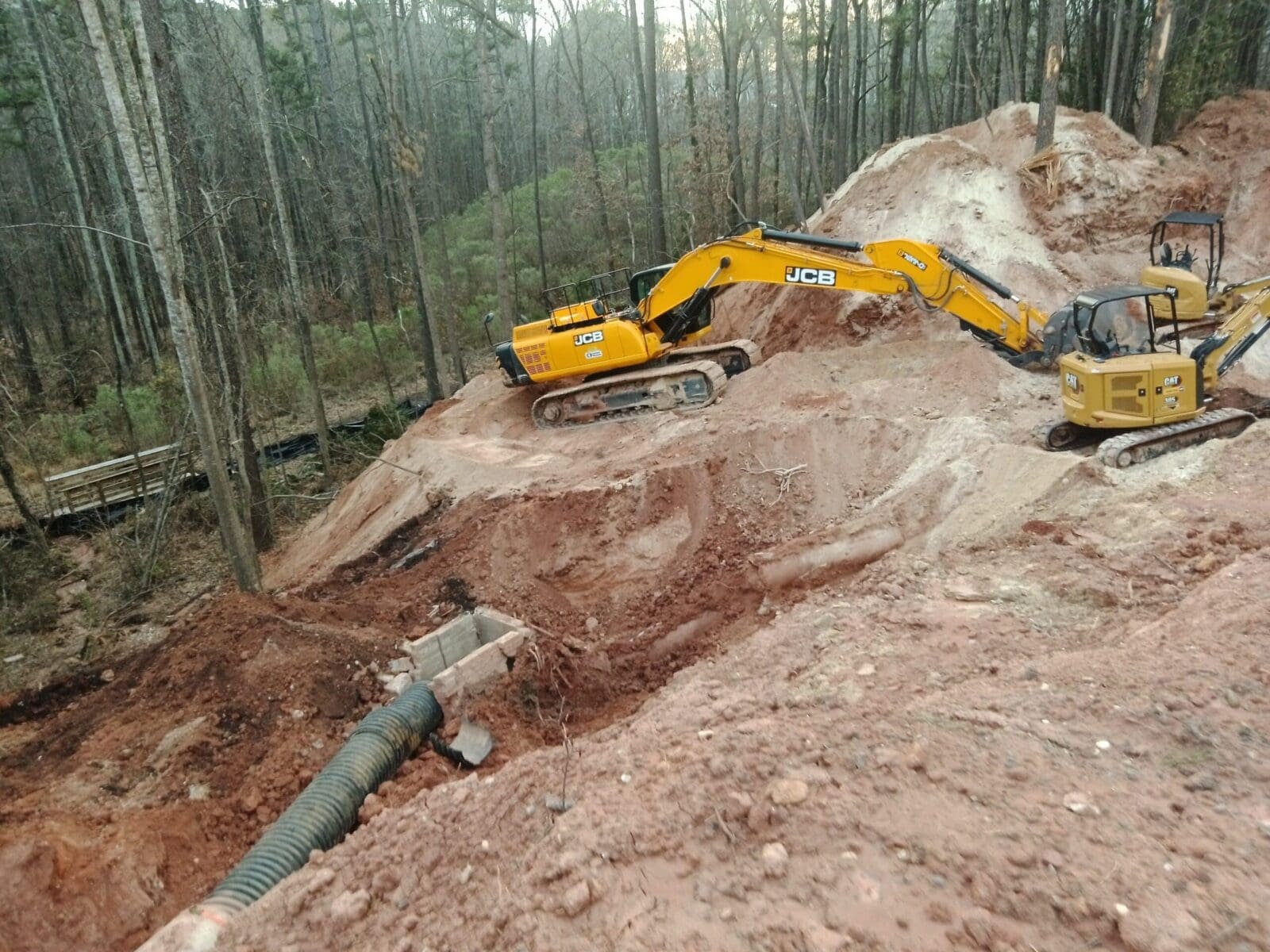 excavators on the side of a hill