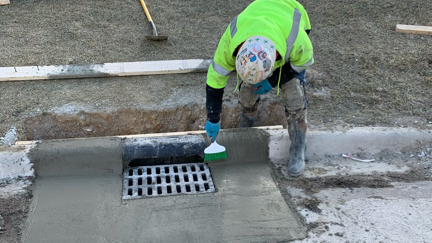 AQUALIS emplyee installing a new catch basin