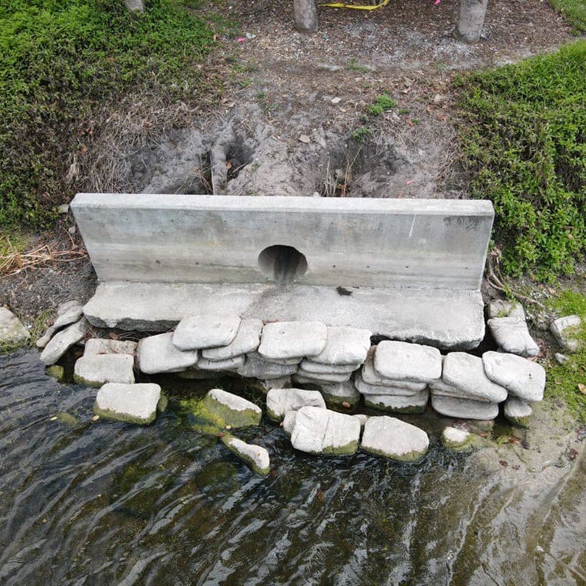 stormwater outfall by a pond