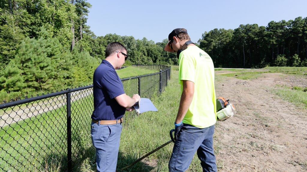 AQUALIS employees looking at clipboard outside