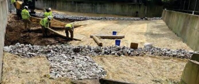 workers laying stabilization mats inside detention basin in Franklin, Tennessee