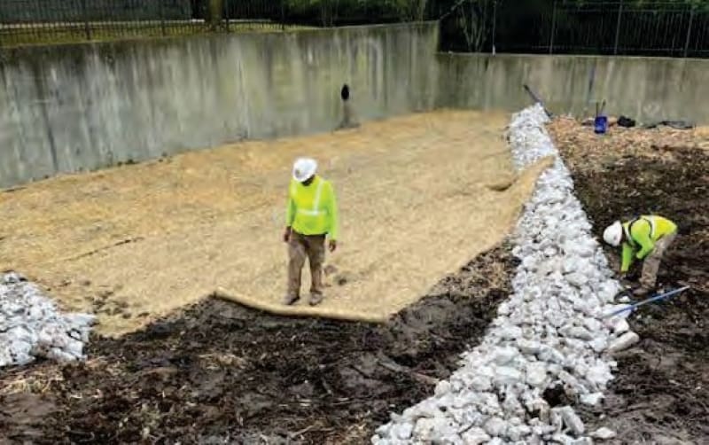 AQUALIS employees in a detention pond