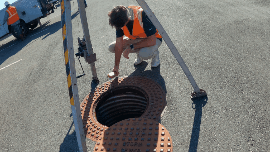 man inspecting a storm sewer