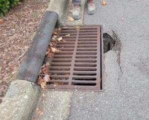 aging sewer grate on a curb